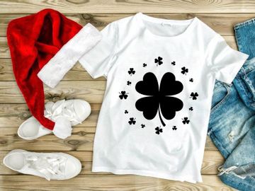 Black four-leaf clover with scattered petals on white background preview picture
