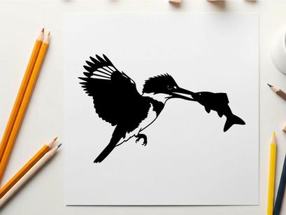 Silhouette of a bird catching a fish in mid air