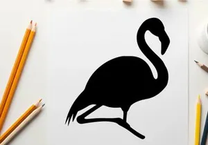 Silhouette of a flamingo standing on one leg