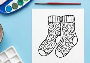 Hand-drawn festive Christmas socks with ornate snowflake and swirl patterns for holiday decor