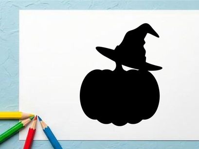 Silhouette of a witch with a broomstick on a pumpkin at night