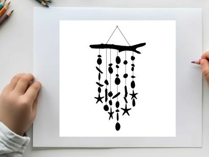 Silhouette of a driftwood wind chime with starfish and sea inspired shapes