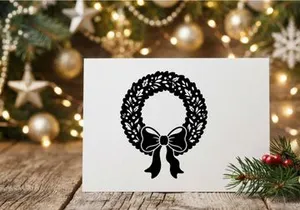 Black Christmas wreath silhouette with decorative bow isolated on white background