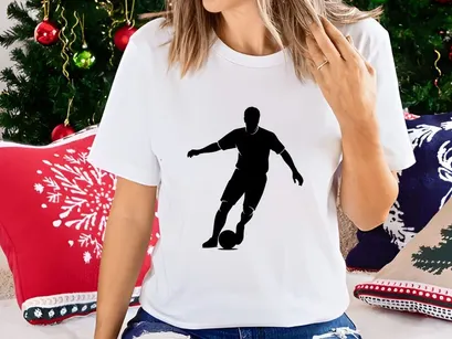 Silhouette of a soccer player kicking a ball in action