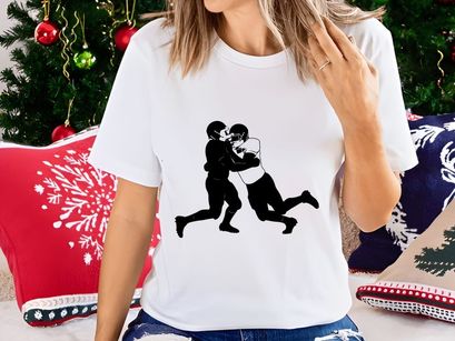 Two football players in intense physical contact during a game