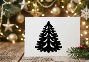 Minimalist black paper Christmas tree ornament isolated on a clean white background