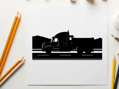 Silhouette of a large truck driving on a road with mountains