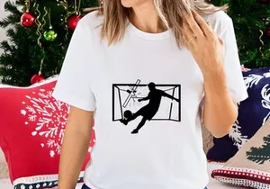 Soccer player kicking ball into goal with outstretched arms in mid air motion