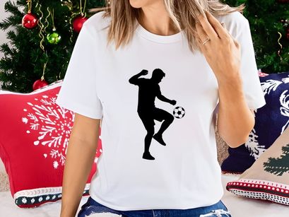 Silhouette of a soccer player kicking a ball with dynamic movement and energy