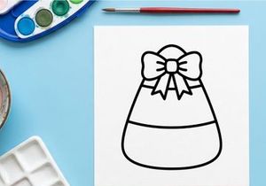 Candy corn icon with a bow. Halloween treat graphic for seasonal holiday design projects.