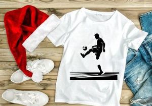 Silhouette of a soccer player kicking a ball in mid action