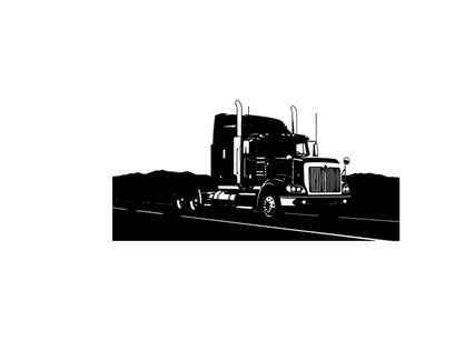 Silhouette of a semi truck driving on a highway with mountains