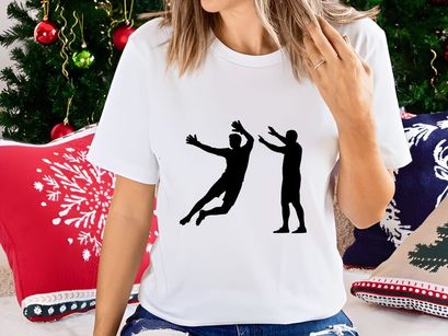 Two black silhouettes of men playing volleyball in mid air and standing