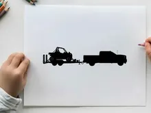 Silhouette of a truck towing a trailer with a vehicle