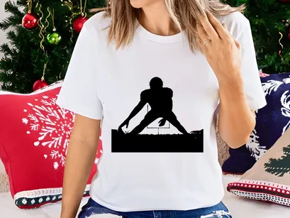 American football player silhouette at sunset on field with goalposts