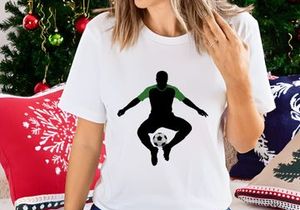 Soccer player in mid air balancing ball on foot in green and black silhouette
