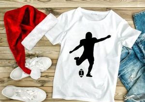 Rugby player kicking a rugby ball in mid action silhouette