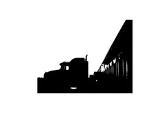 Truck silhouette parked beside a building at sunset