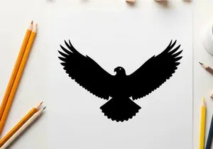 Black silhouette of an eagle in flight with wings spread wide