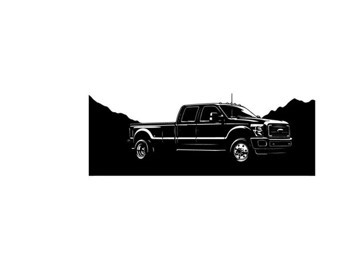 Silhouette of a pickup truck against a mountain range silhouette