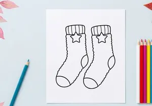 Christmas socks line art illustration with star pattern for holiday coloring page design.