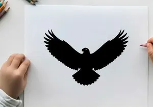 Black silhouette of an eagle in flight with wings spread wide