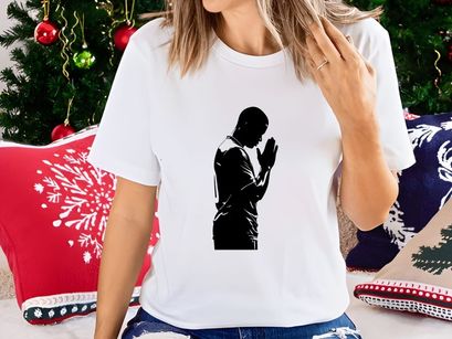 A man in prayer with hands clasped together in devotion and contemplation