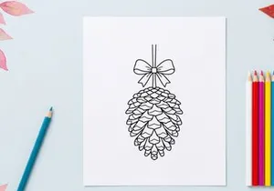 Decorative pine cone ornament hanging from a string. Festive holiday decor for Christmas and winter celebrations.