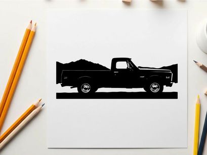 Silhouette of a pickup truck against a mountain range silhouette