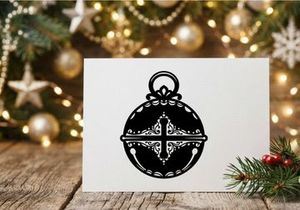 Black and white Christmas jingle bell icon with ornate filigree cross design