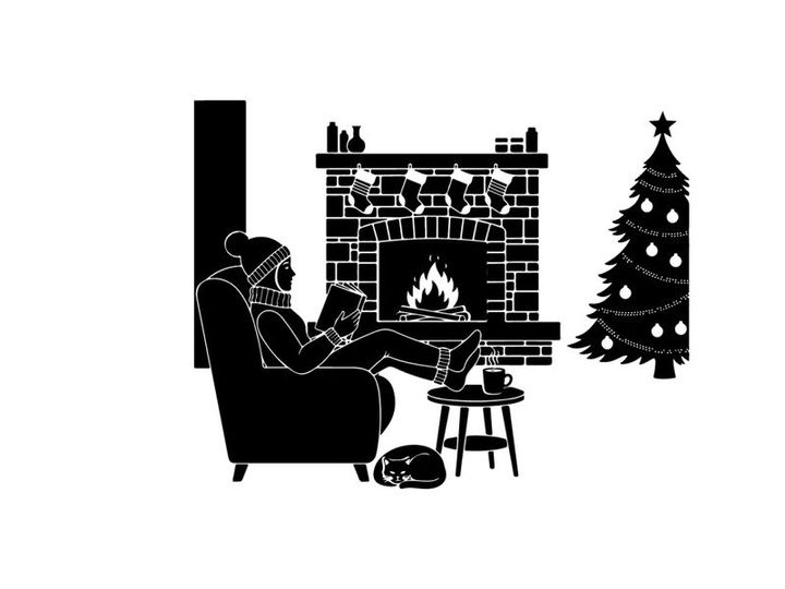 Cozy silhouette of man reading by christmas fireplace