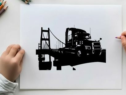 Silhouette of a semi truck driving across a suspension bridge