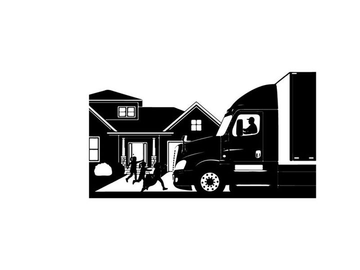 Silhouette of moving truck parked at suburban home with people