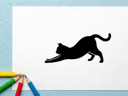 Silhouette of a playful black cat stretching on white background