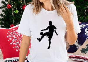 Silhouette of a soccer player kicking a ball in mid action