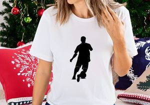 Silhouette of a soccer player kicking a ball in action