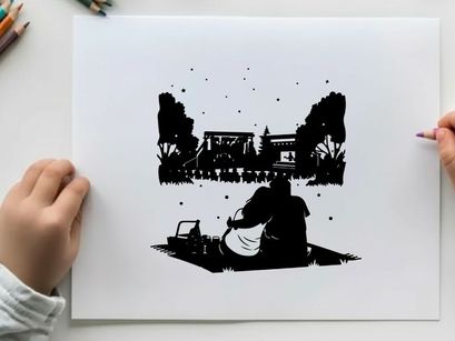 Silhouette of a couple watching a movie outdoors at night