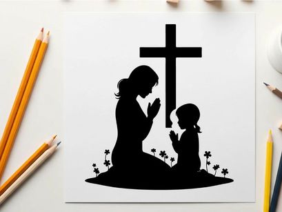 Silhouette of mother and child praying by cross