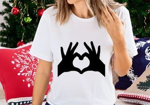 Hands forming heart shape shadow love symbol on white background