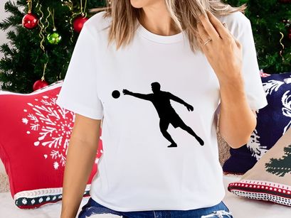 A silhouette of a man playing handball in dynamic motion with a ball