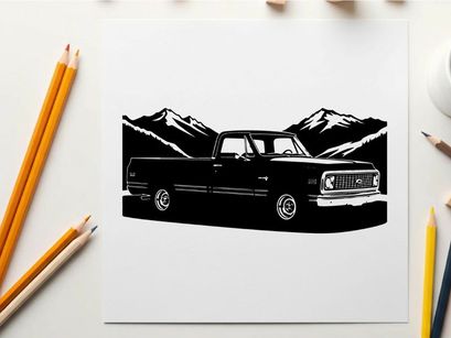 Silhouette of a classic pickup truck against mountain range silhouette