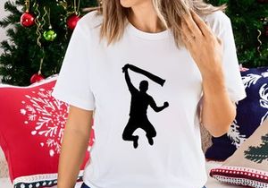 A silhouette of a person jumping and waving a scarf or cloth in the air energetically