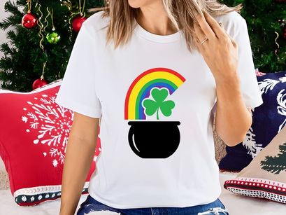 Lucky pot of gold with rainbow and shamrocks in black cauldron