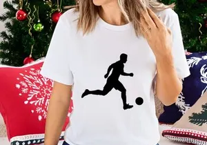 Silhouette of a soccer player kicking a ball in motion