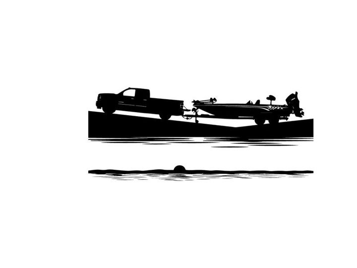 Silhouette of a pickup truck towing a boat on a trailer by the water