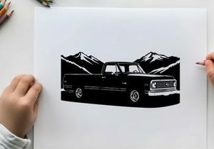Silhouette of a classic pickup truck against mountain range silhouette