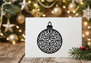 Decorative Christmas ornament with intricate black filigree design