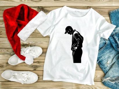 A man in a baseball cap standing with his hands on his stomach