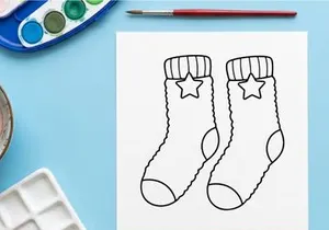 Christmas socks line art illustration with star pattern for holiday coloring page design.