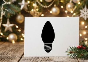 Black silhouette of a Christmas light bulb isolated on a white background